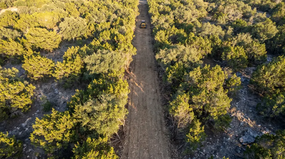Survey line clearing in Texas: aerial view of a straight survey line cleared through cedar and oak woodland